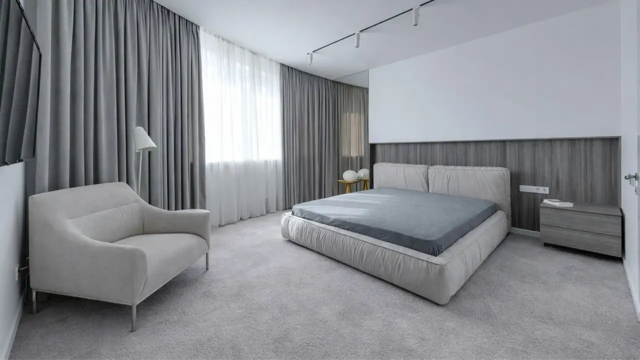Modern bedroom featuring soft grey carpet flooring with clean installation and a comfortable finish, ideal for professional carpet installation in Geelong.
