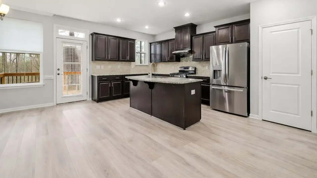 Modern kitchen featuring premium vinyl flooring in Geelong with light wood-look planks, seamless installation, and a clean contemporary finish.