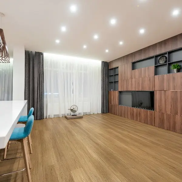 The results of a professional hybrid flooring installation: showcasing precise joint alignment, clean perimeter spacing, and a durable, aesthetically pleasing finish by Jim's Flooring.