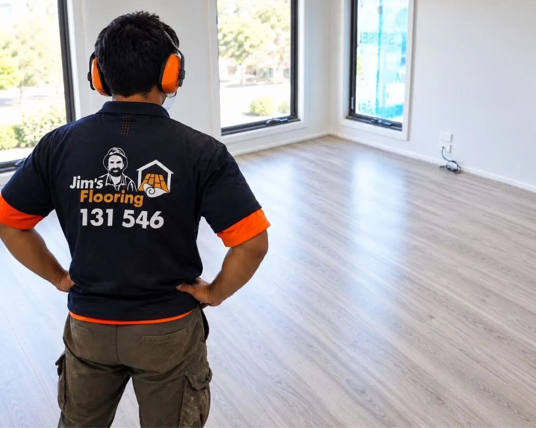 A Jim's Flooring Installer looking at his completed Hybrid Flooring Installation work.
