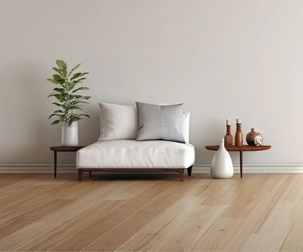 Stylish living room with light laminate flooring, a white sofa, and minimalist décor.