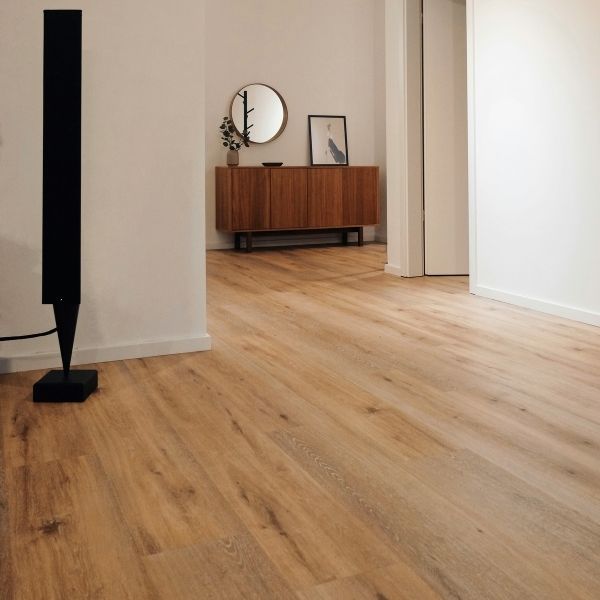 A modern living space with freshly laid timber floors and minimal decor.