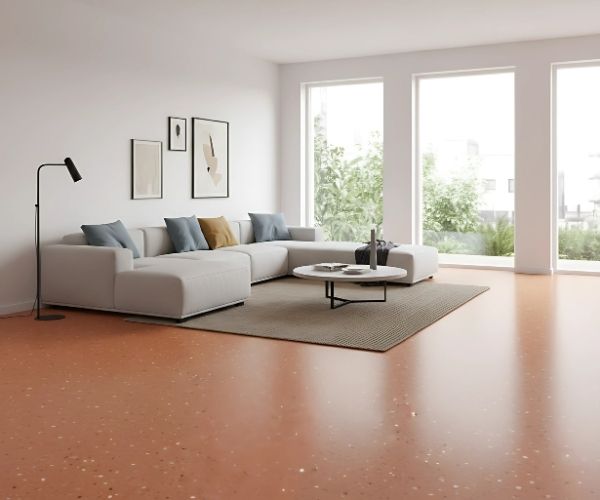 Modern Melbourne living room with terracotta vinyl flooring, white sectional sofa, floor lamp, and large windows bringing in natural light.