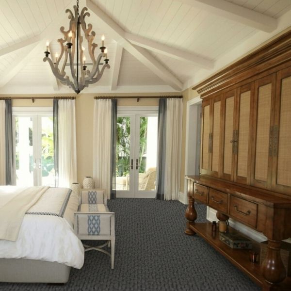 Carpet flooring installation in a Perth bedroom, showcasing a plush carpet finish, classic furniture, and a warm, comfortable interior design.