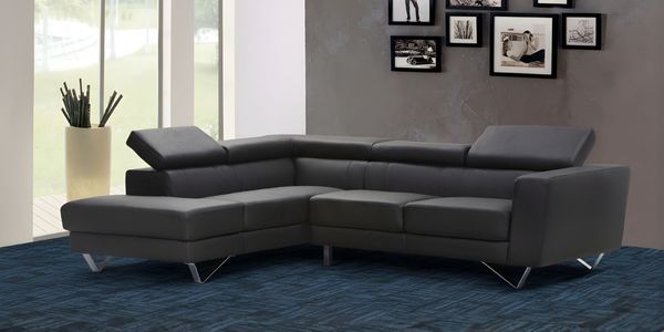 Carpet tiles installed in a contemporary living room, featuring a textured tile pattern paired with a modern sectional sofa and minimalist décor.