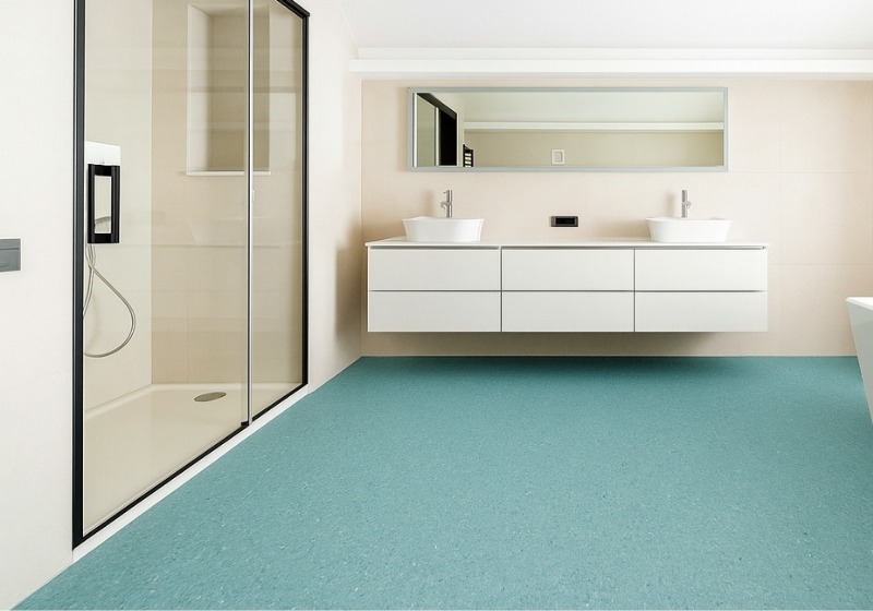 Modern Perth bathroom featuring waterproof vinyl flooring, with a minimalist double vanity, glass shower, and freestanding bathtub designed for moisture-resistant performance.