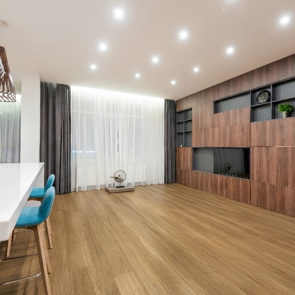 The results of a professional hybrid flooring installation: showcasing precise joint alignment, clean perimeter spacing, and a durable, aesthetically pleasing finish by Jim's Flooring.